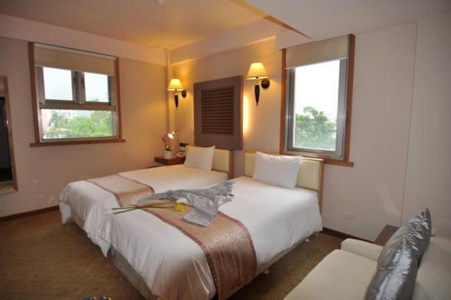 Postel nebo postele na pokoji v ubytování Tian Long Hotel
