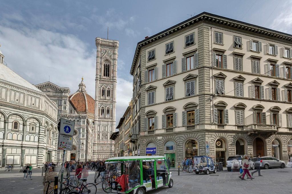 a city street with a trolly in front of a building at Il Salotto Di Firenze in Florence