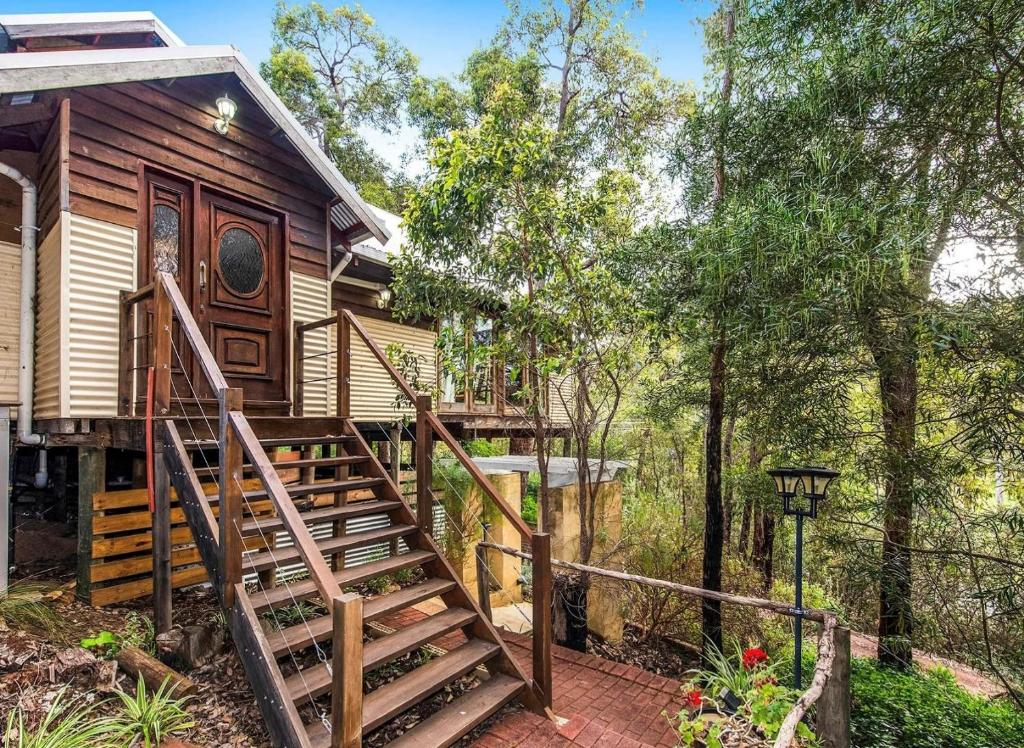 a stairway leading to a cabin in the woods at Bickley Tree Stay in Bickley