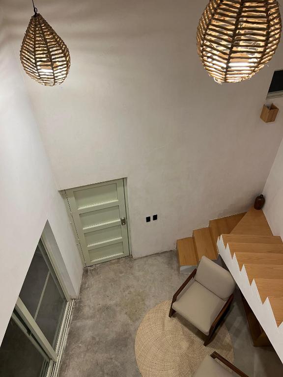 a room with a table and a chair and a door at Casa Tonalli in Jocotepec
