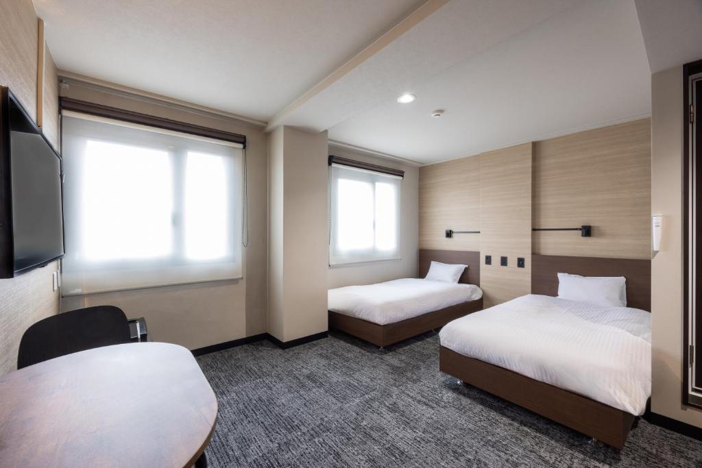 Postel nebo postele na pokoji v ubytování Fukuyama Royal Hotel
