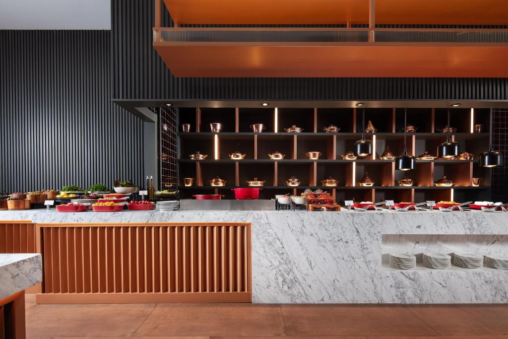 a lobby of a restaurant with a counter at Delta Hotels by Marriott Istanbul Vadi in Istanbul