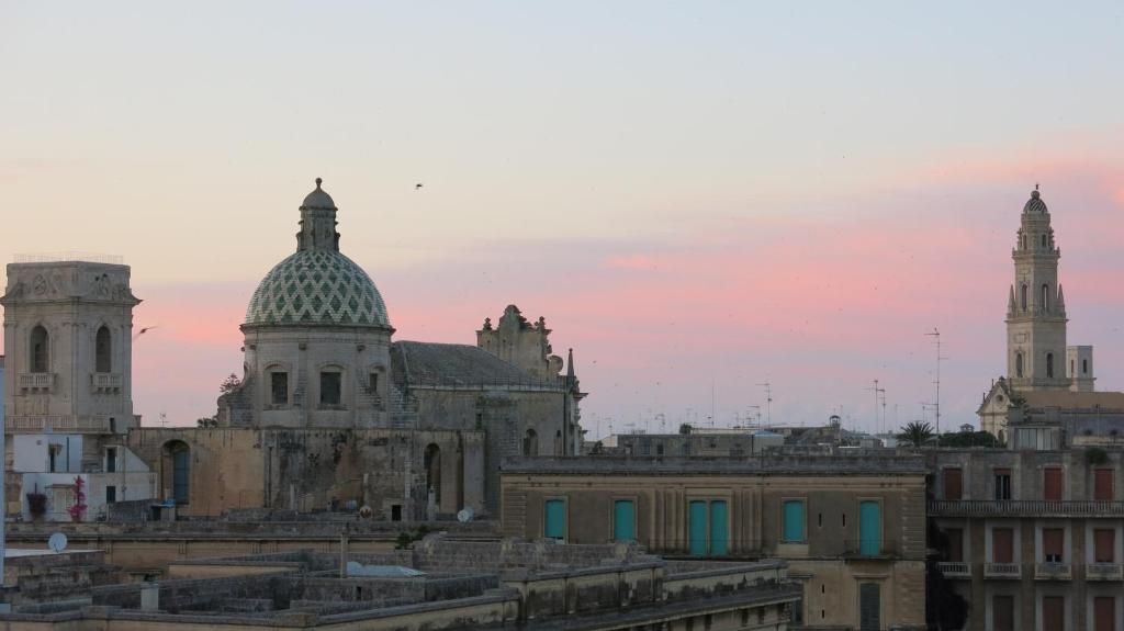 a group of buildings with domes in a city at Volver B&B in Lecce