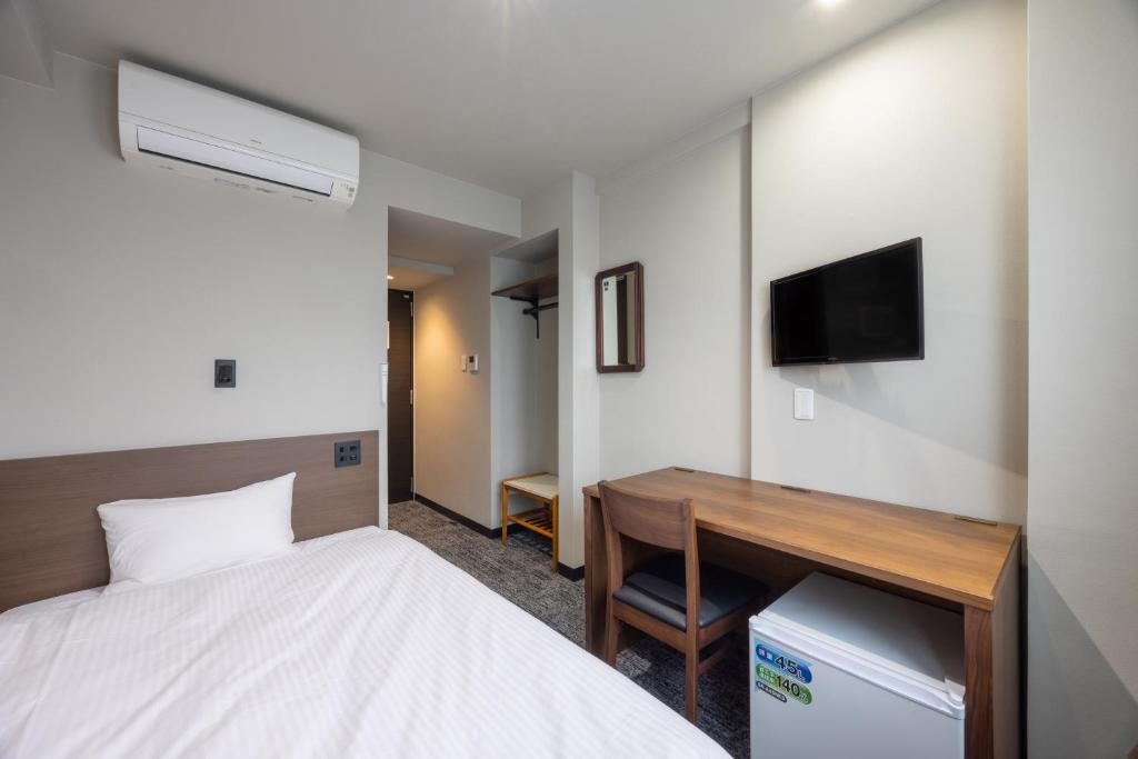 Postel nebo postele na pokoji v ubytování Fukuyama Royal Hotel