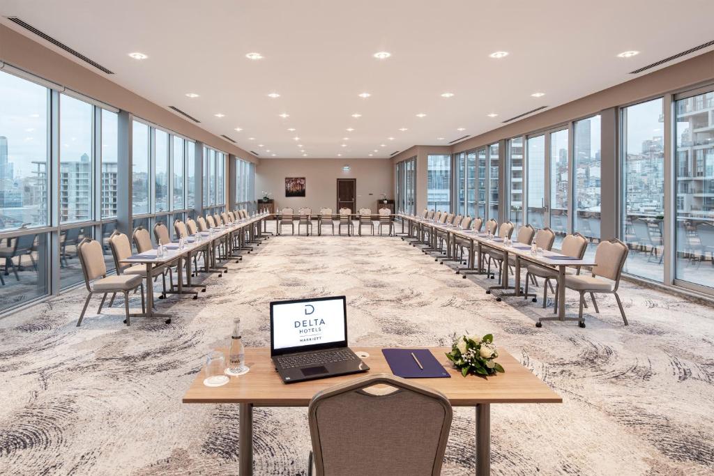 a conference room with tables and chairs and a laptop on a table at Delta Hotels by Marriott Istanbul Vadi in Istanbul