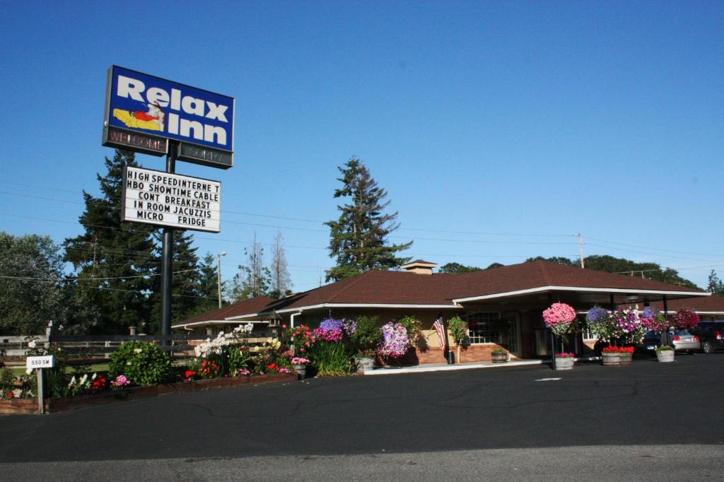 a restaurant with a sign in front of a building at Relax Inn Chehalis in Chehalis