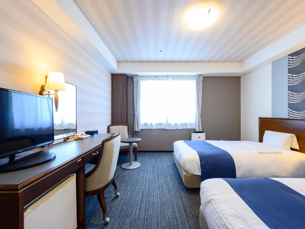 Postel nebo postele na pokoji v ubytování Hotel Green Park Tsu