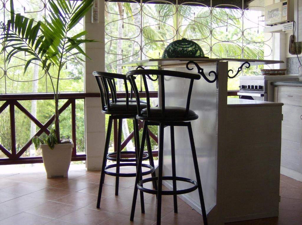 a kitchen with two black bar stools and a counter at The Legend Garden Condos in Saint Peter