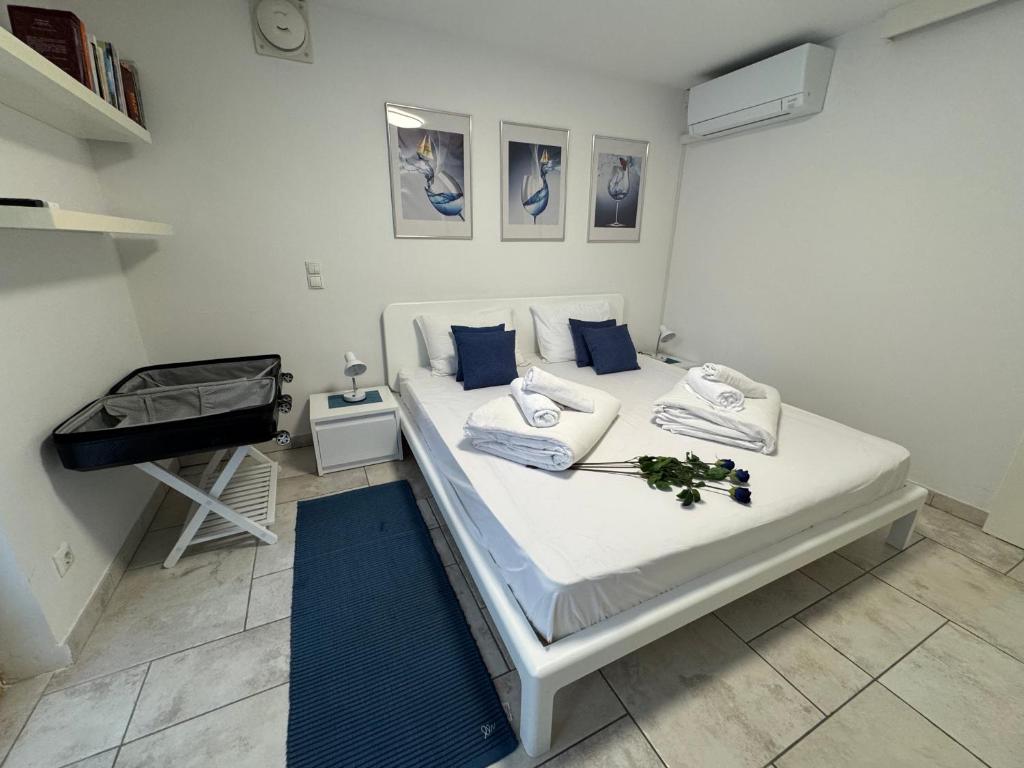 a bedroom with a white bed with blue pillows at Anabella Apartment in Izola