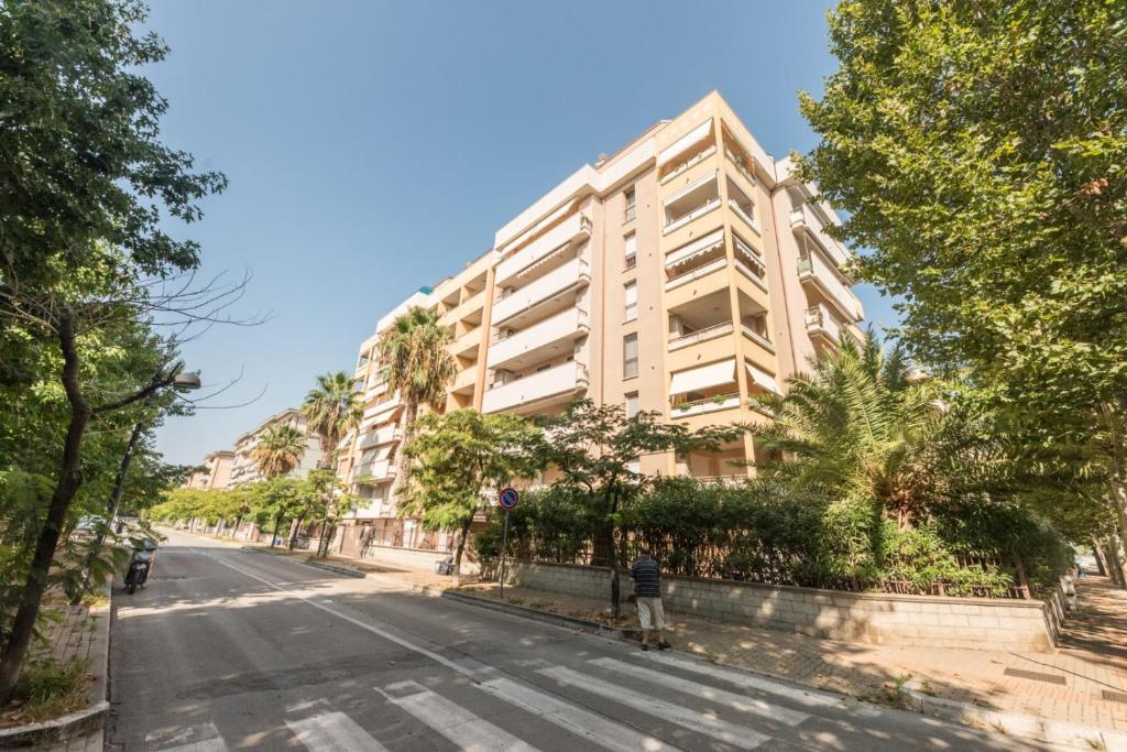 a man standing in front of a building on a street at Casa Le Pleiadi in Montesilvano Marina