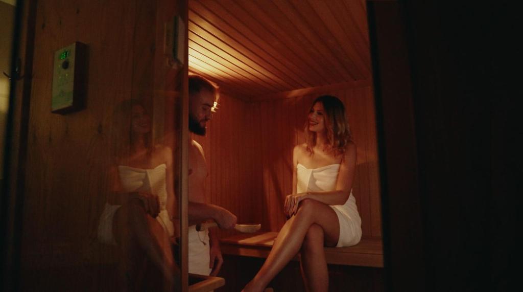 a man and a woman sitting in a room at Hotel Convent - Hotel & Resort Adria Ankaran in Ankaran