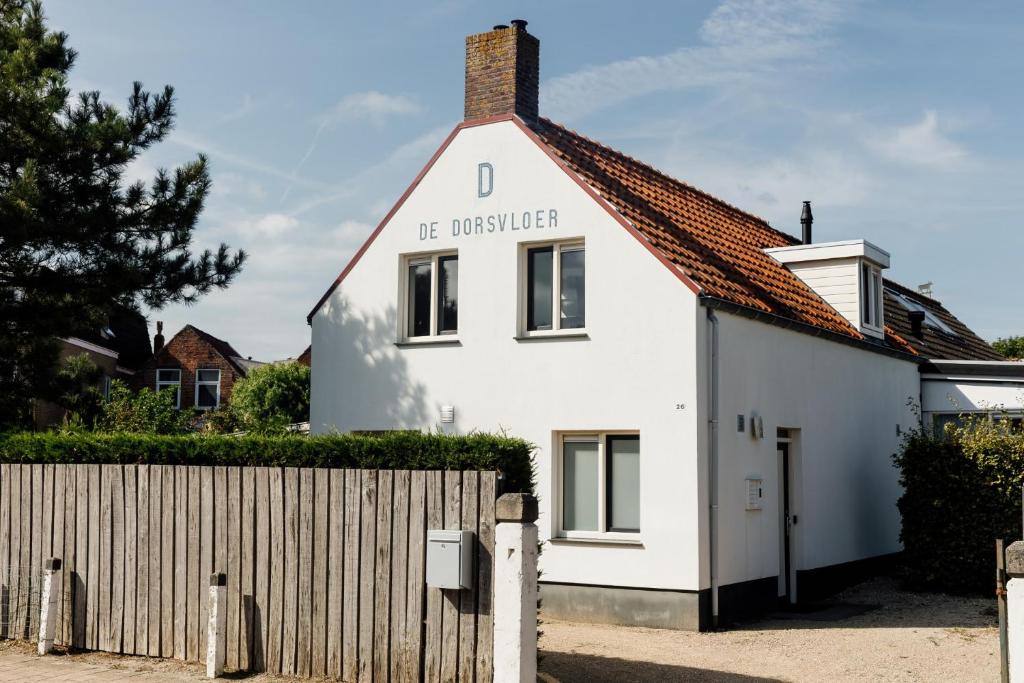 a white house with the university written on it at Bed & Bike De Dorsvloer in Domburg