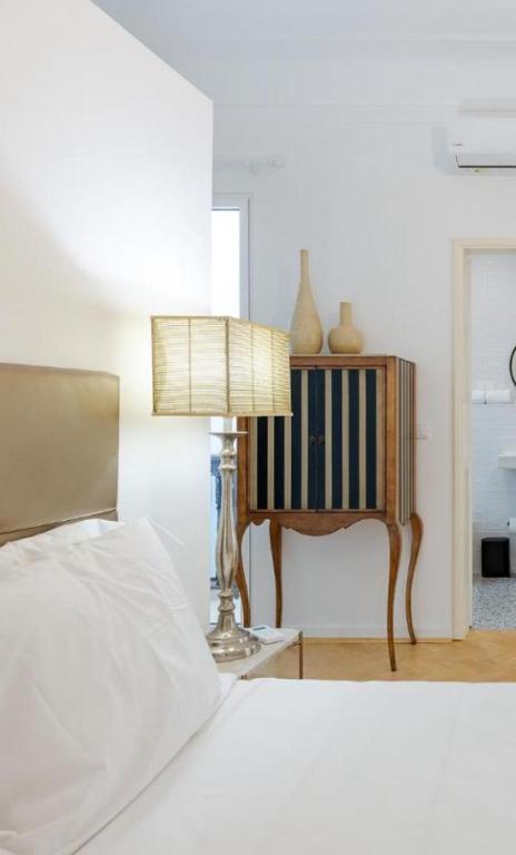 a bedroom with a bed and a table with a lamp at Casa Largo da Mó in Portimão