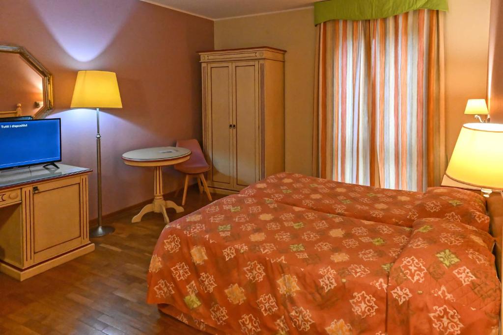 Postel nebo postele na pokoji v ubytování Hotel Matteotti