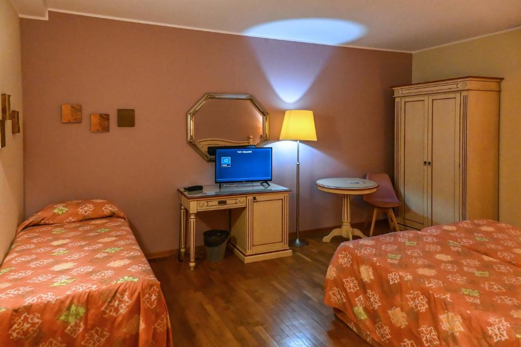 Postel nebo postele na pokoji v ubytování Hotel Matteotti