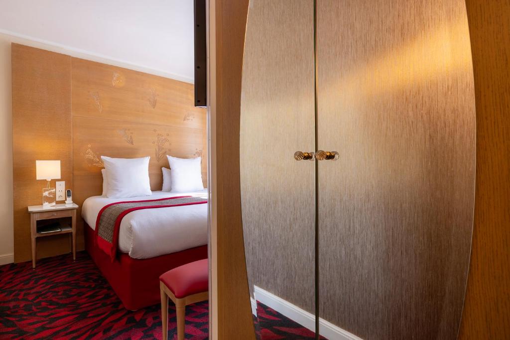 Postel nebo postele na pokoji v ubytování Hotel Muguet