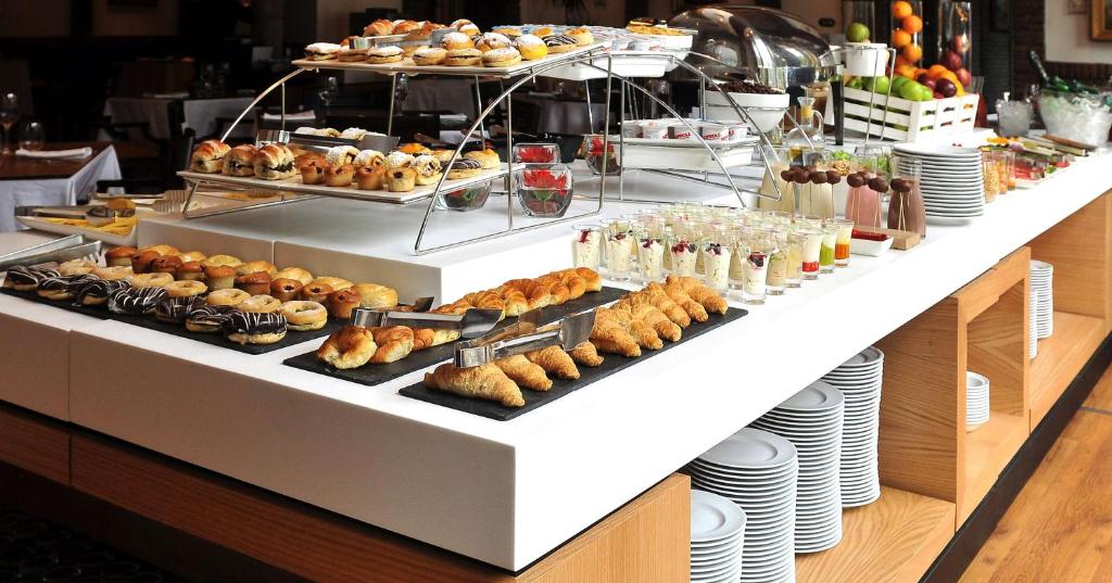 a buffet with many different types of food on display at NH Collection Plaza Santiago in Santiago