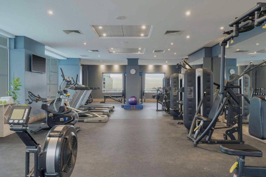 a gym with several treadmills and machines at NH Collection Plaza Santiago in Santiago
