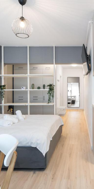 a bedroom with a large white bed and a desk at Springview Studio in Bucharest
