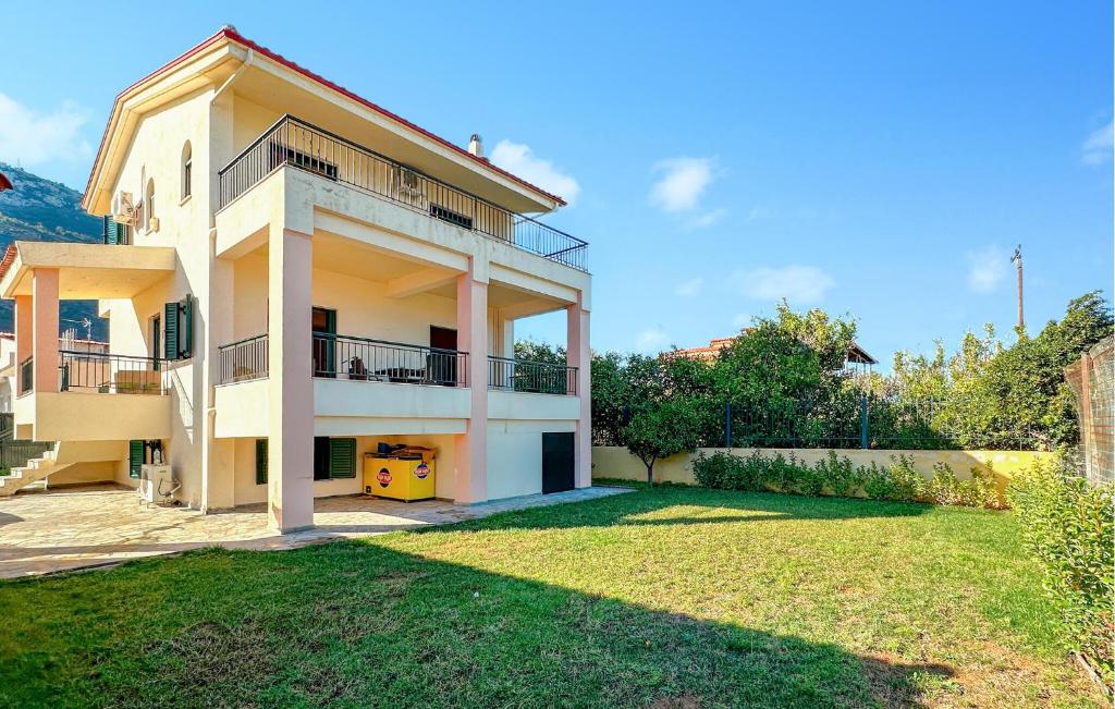 a large house with a yard in front of it at 3 Bedroom Nice Home In Xylokastro in Xylokastron