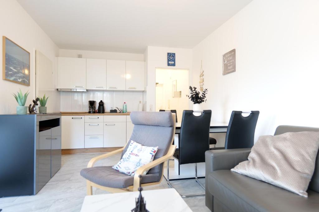 a kitchen and living room with a couch and a table at Terrassenhaus Whg 21 in Duhnen