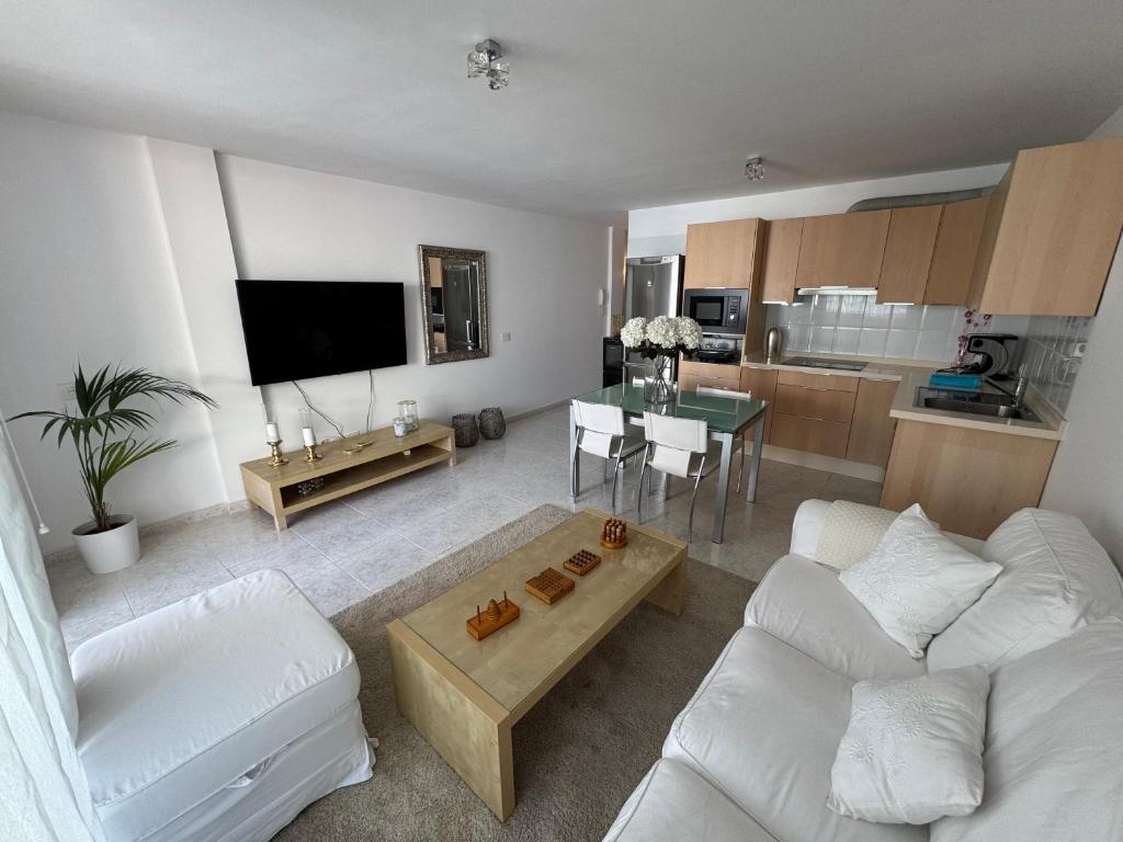 a living room with two white couches and a table at Casa Eva in Los Llanos de Aridane