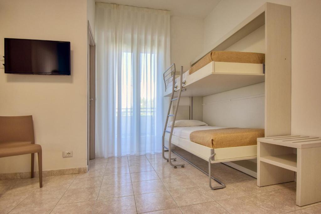 Postel nebo postele na pokoji v ubytování Ambra Hotel Cattolica