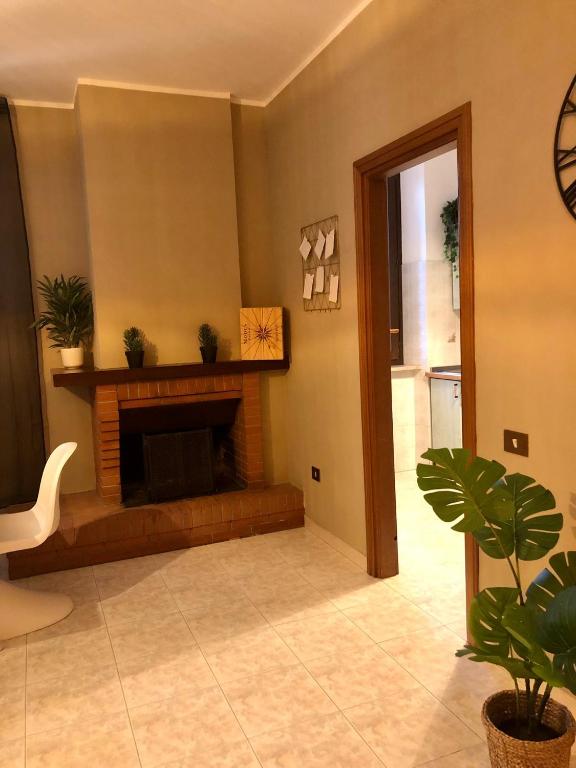 a living room with a fireplace in a house at Santa Filomena Guest House in Terni