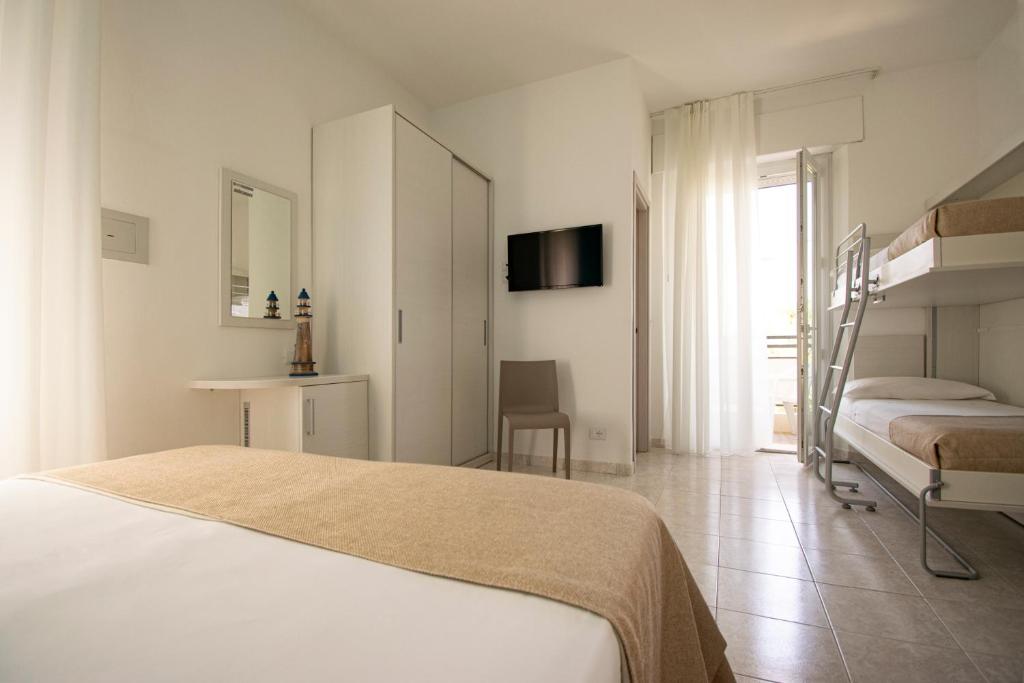 Postel nebo postele na pokoji v ubytování Ambra Hotel Cattolica