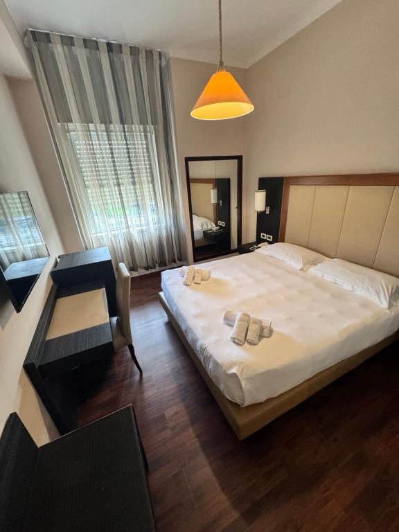 Postel nebo postele na pokoji v ubytování Grand Hotel Lamezia