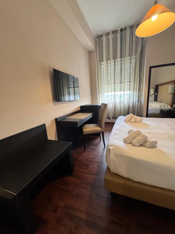 Postel nebo postele na pokoji v ubytování Grand Hotel Lamezia