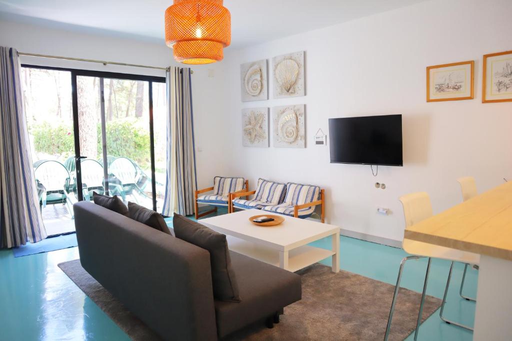 a living room with a couch and a table at PH in Aroeira Lisbon - Beach & Golf in Aroeira