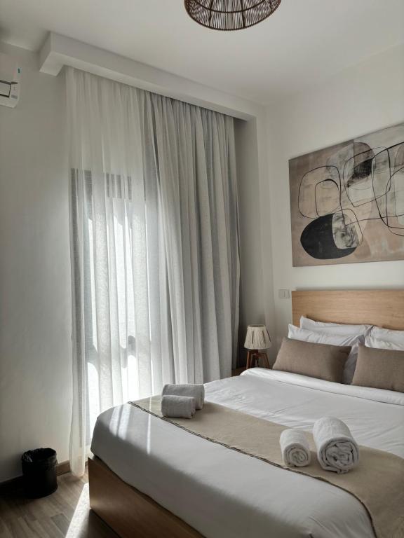 a bedroom with a large bed with towels on it at 2BR Modern & Comfy Apartment in luxury neighbourhood in Madinaty
