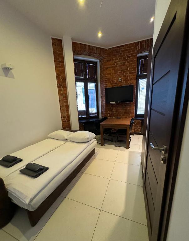 Łóżko lub łóżka w pokoju w obiekcie Aparthotel Łódź 55 Piotrkowska