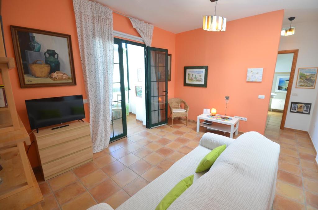 a living room with a couch and a tv at Casa Ana Rosa Good location & Close to the beach in Playa Blanca