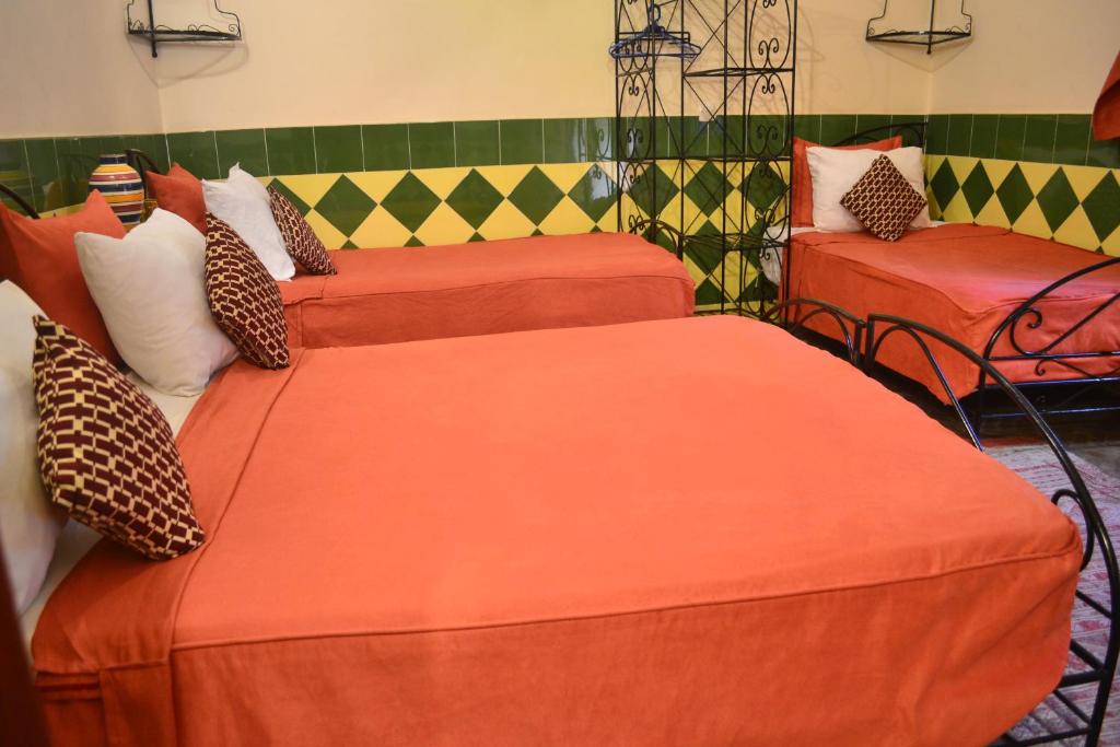 Postel nebo postele na pokoji v ubytování Riad Hôtel Belleville Marrakech