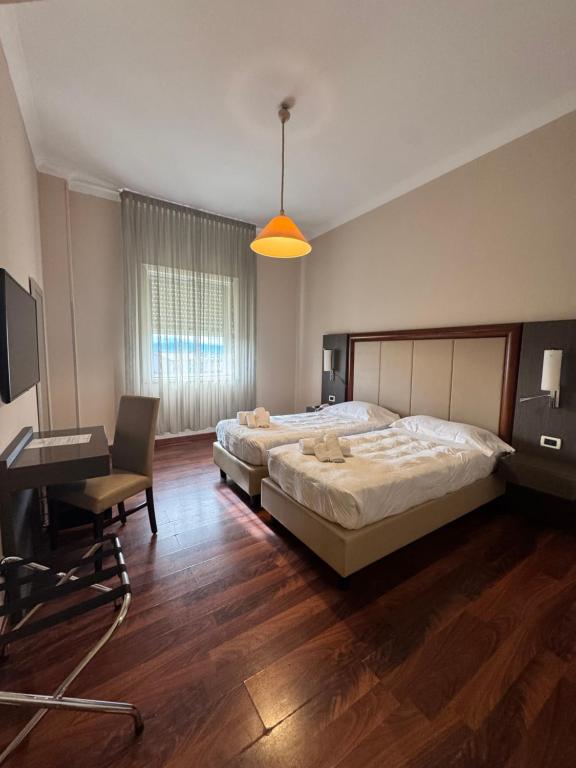 Postel nebo postele na pokoji v ubytování Grand Hotel Lamezia