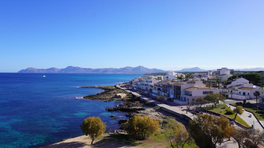 a view of a town on the water at Mar y Paz by Youroom in Can Picafort