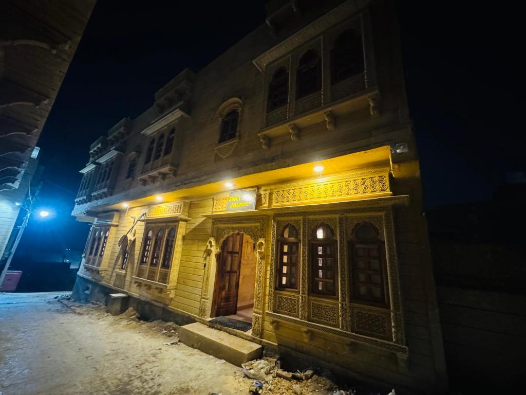 an old building with yellow lights on it at night at Silent Sands Jaisalmer in Jaisalmer