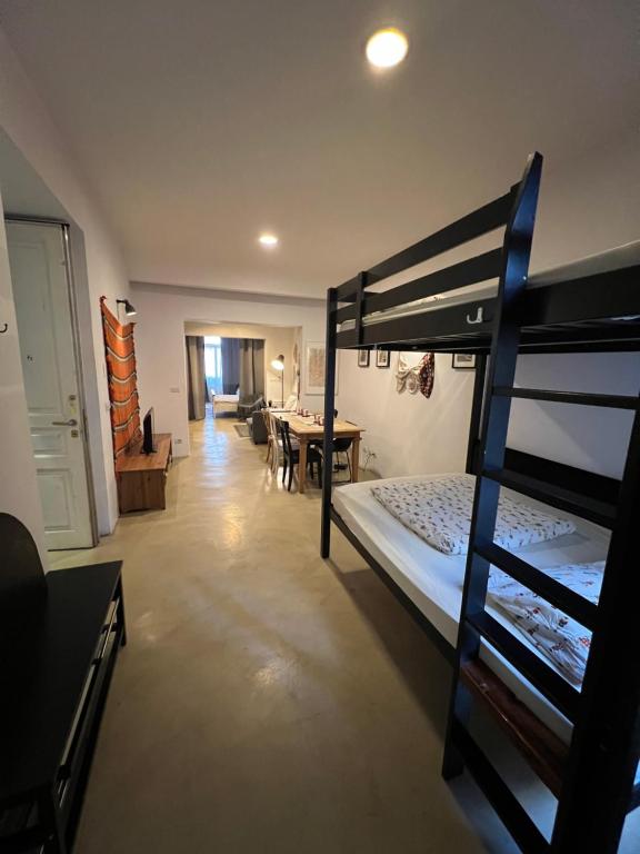 a bedroom with a bunk bed and a living room at Transylvania Apartment old town in Bucharest