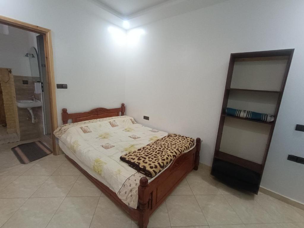 a bedroom with a bed in a room with a mirror at Future in Taghazout