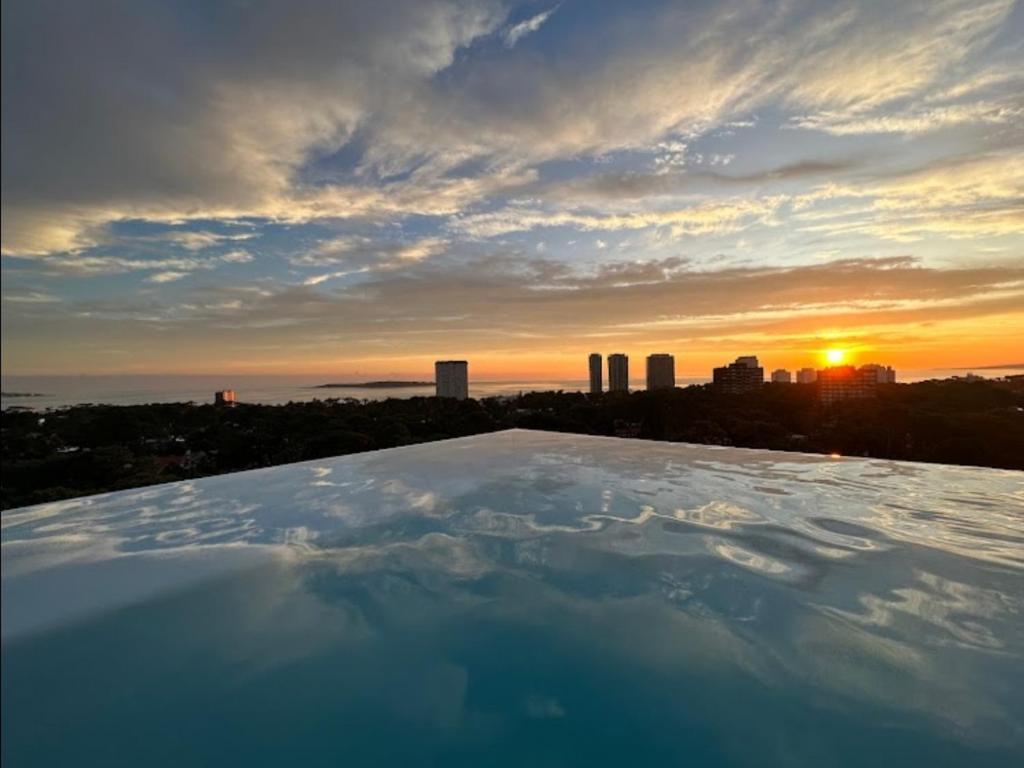 a view of the sunset from the roof of a building at Apartamento Acapulco in Punta del Este