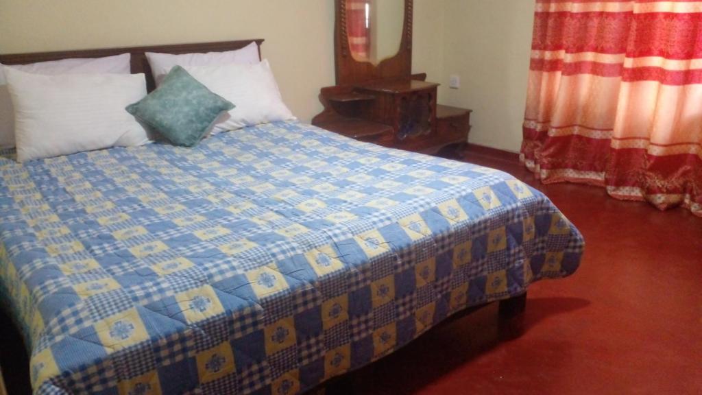 Postel nebo postele na pokoji v ubytování Haranya Homestay
