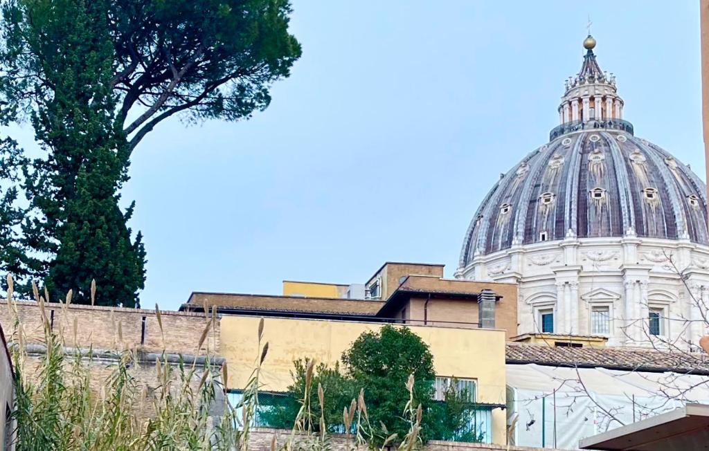 a building with a dome in the background at Vista Cupola House in Rome
