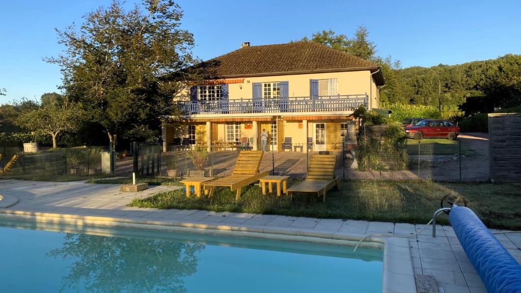 a house with a swimming pool in front of a house at Le Petit Bouleau in Saint-Pardoux-la-Rivière