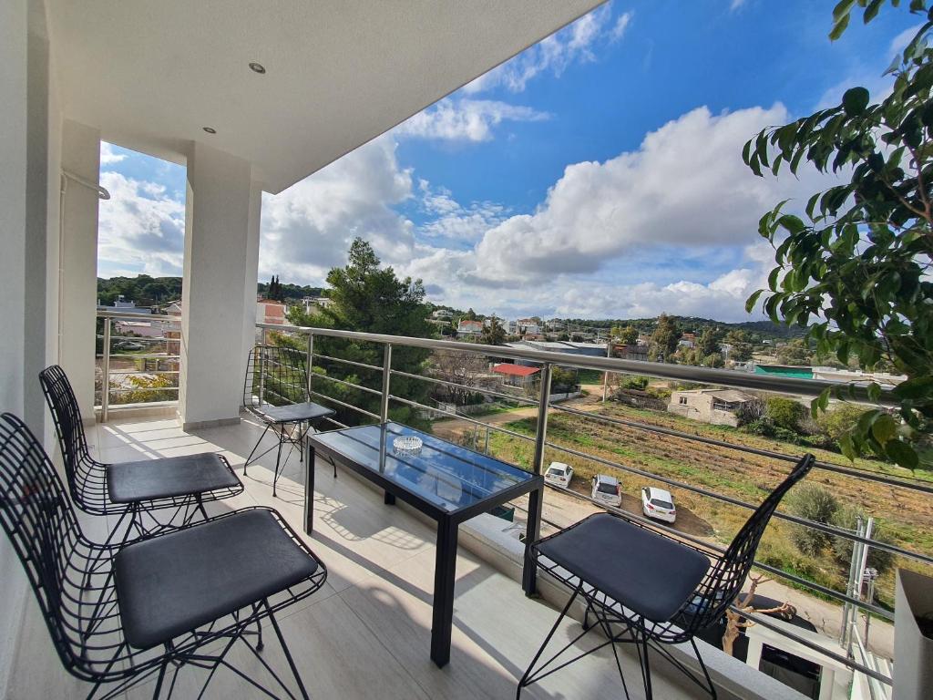 a balcony with a table and chairs and a view at Hi Hellas 4 in Artemida