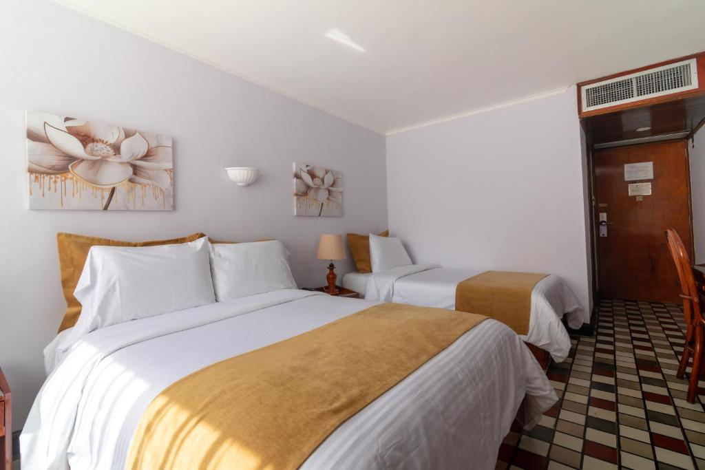 Postel nebo postele na pokoji v ubytování Hotel Bahia Cartagena