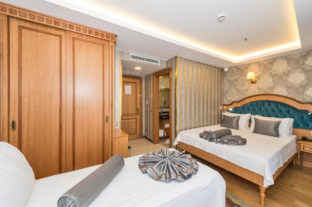 Postel nebo postele na pokoji v ubytování Aprilis Gold Hotel - Special Category