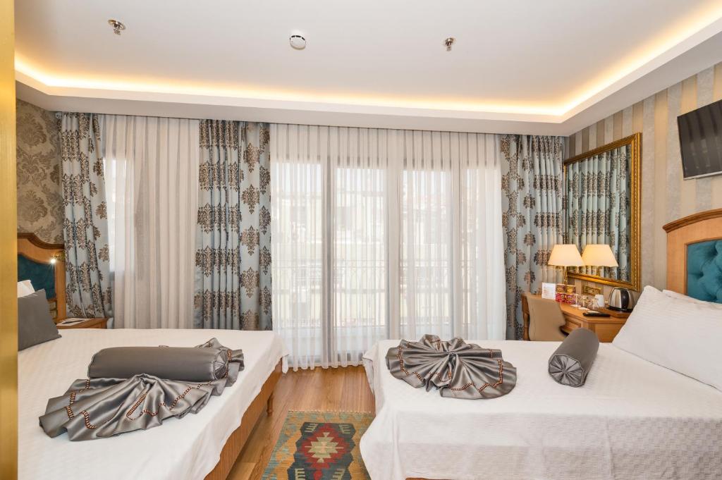 Postel nebo postele na pokoji v ubytování Aprilis Gold Hotel - Special Category