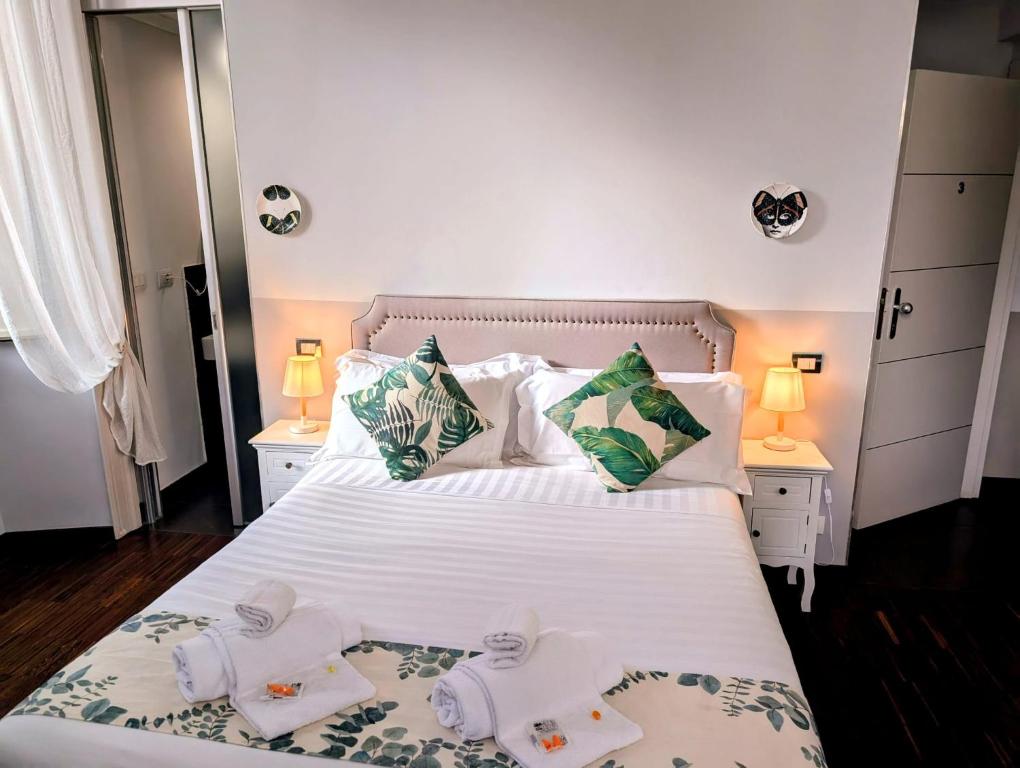 a bedroom with a white bed with two towels on it at DM69 - Termini Monti Crossroads in Rome